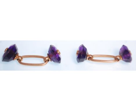 A pair of antique gold and amethyst cufflinks having oval cut amethysts united by gold connectors. Weight 4.4g. Stones measur