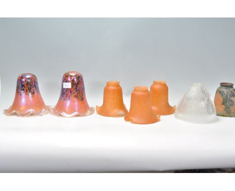 A collection of 20th century art glass lamp - light shades. To include 2 stunning art glass volcanic style, 3 orange glass sh