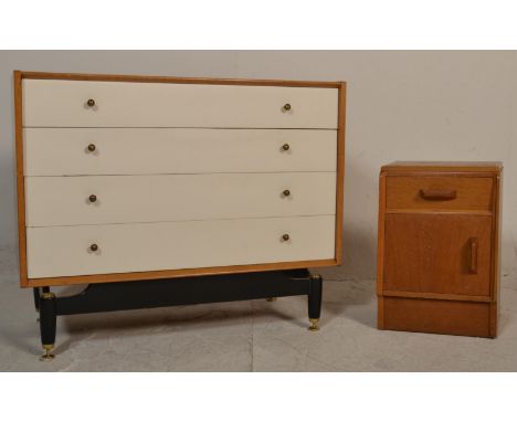E. Gomme- G Plan- Brandon Range- A retro 20th Century light oak chest of drawers raised on ebonised supports having four whit