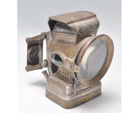 An early 20th century vintage bicycle lamp by Silver King. The lamp with original clasp to back with large circular lamp havi