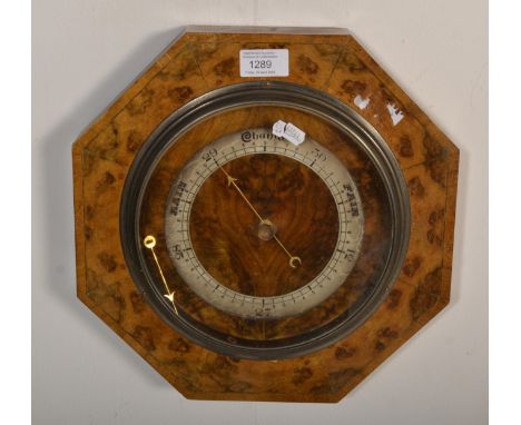 A vintage 20th Century burr walnut barometer of octagonal form having a silvered dial.&nbsp; Measures 31 x 31 x 5cm.