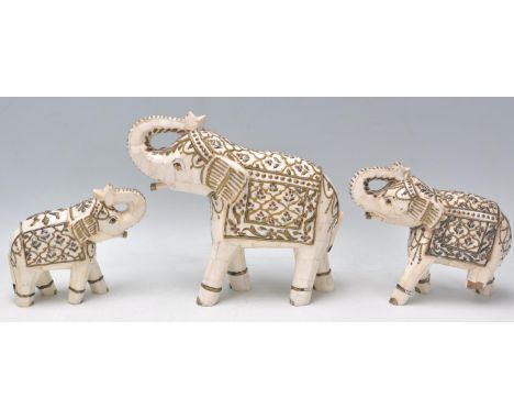 A group of three vintage 20th Century bone Indian elephants having a hand painted and gilt decoration. Tall measures 19cm tal
