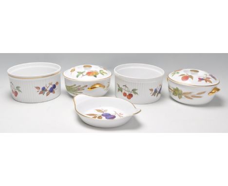 A collection of Royal Worcester Evesham ceramics to include two bowls, two tureens and a service dish, all decorated with fru
