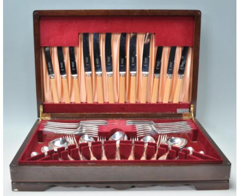 A vintage 20th Century oak cased canteen of cutlery housing a full set of Viceroy Silver Plate cutlery with bone handle knive