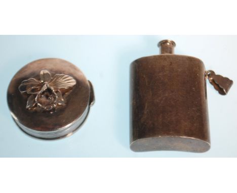 A silver hallmarked pill box embellished with a flower to the lid, of roundel form together with a silver miniature hip flask
