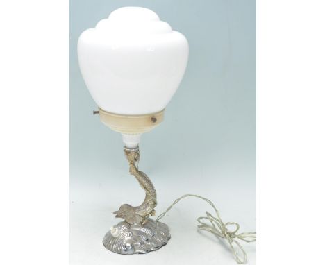 A vintage retro Art Deco table lamp having a round stepped design shade with Maltese dolphin design support on a base in the 