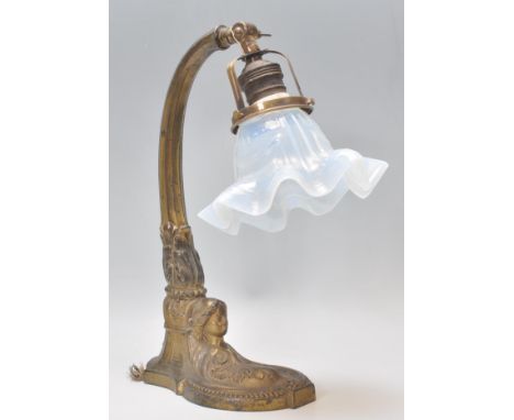 An early 20th Century Art Nouveau brass table / desk lamp having an opaline glass handkerchief shade. The base having moulded