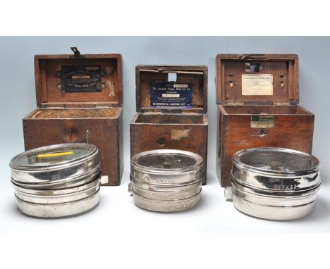 Two oak cased vintage 20th Century Pigeon clocks, both clocks housed in chrome cases within oak carry cases having leather ha