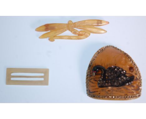 An early 20th Century 1920's early plastic celluloid brooch of triangular form with an applied black swan set with rhinestone