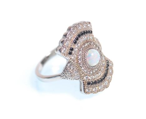 A stamped 925 silver art deco style panel ring set with a central round cut opal and white and black accent stones. Weight 4.