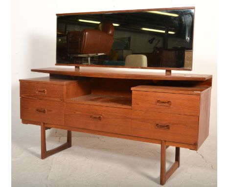 A vintage retro 20th Century teak wood dressing table chest having large rectangular mirror back in the manner of Mogens Kolo