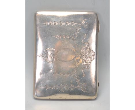 An early 20th Century silver hallmarked cigarette case having finley engraved floral and ribbon decoration. Hallmarked for Bi