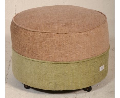 A retro mid century circular barrel foot stool pouffe in a two tone upholstered colourway of beige and pink. Set to block fee