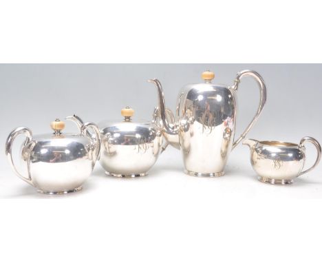 An American early 20th Century believed silver sterling 4 piece tea / coffee service by Barbour bearing chased monogram with 