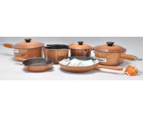 Le Creuset - A set of five graduating cast iron French saucepans and lids ( one lid missing ), finished in a light brown colo