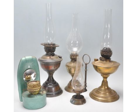 A mixed group of vintage oil lamps dating from the 19th Century to include a wall hanging example finished in metallic green 