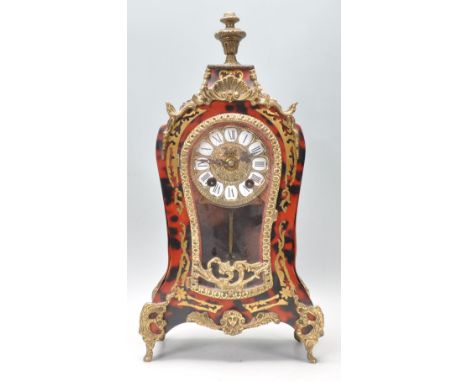A 20th Century Walt rococo style faux tortoise shell mantel clock of waisted from being raised on gilt scrolled legs with a r