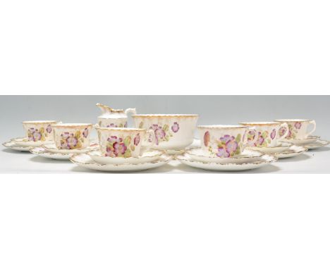 A 19th Century Victorian tea service decorated with painted purple flowers to the sides with gilt rims. Consists of sugar bow