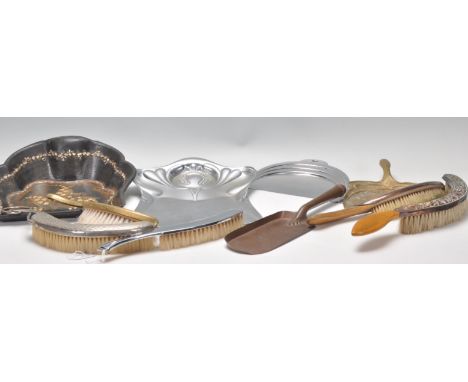 A good mixed collection of crumb trays and brushes dating from the 19th Century to include a chrome Art Nouveau tray and a br