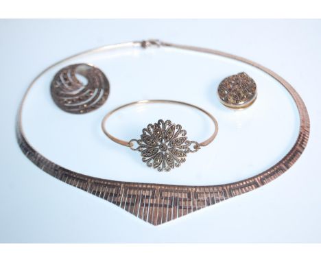 A selection of silver jewellery to include a a collar necklace of graduation greek key design, a crossover brooch set with ma