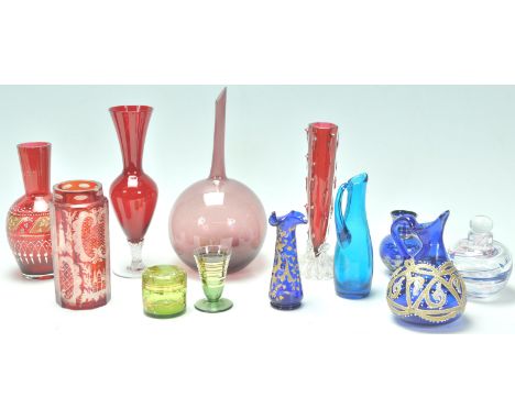 A collection of 20th Century bohemian glass to include a faceted ruby glass being acid etched with country scenes, a ruby gla