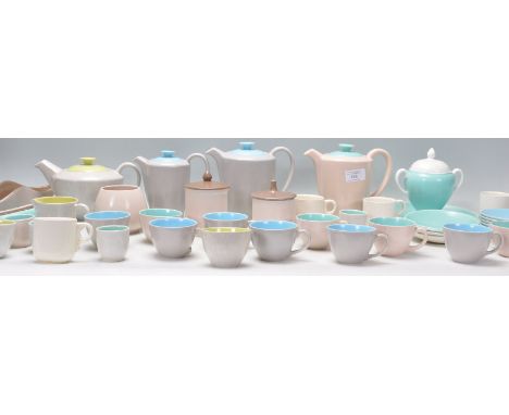 A collection of vintage Poole pottery to include coffee pots, tea pot, cups and saucers, sugar bowls etc. All having cream ex