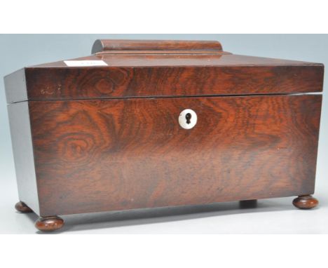 A 19th Century Victorian mahogany tea caddy of sarcophagus raised on bun feet with mother of pearl escutcheon. The hinged lid