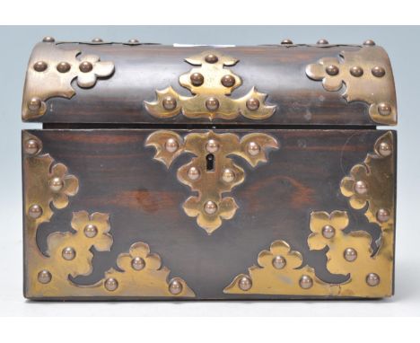 A Victorian 19th century coromandel dome top casket caddy with good armorial oversized brass strap hinges and embellishments 