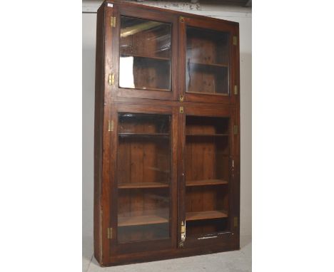 A Victorian 19th century mahogany haberdashery shop display cabinet in the campaign style. The large upright body having twin