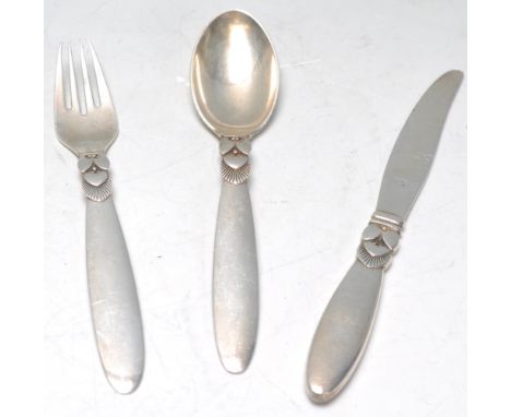 A Georg Jensen silver Cactus pattern three piece christening set comprising knife, fork and a spoon being stamped for Sterlin