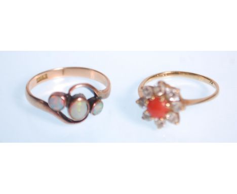 A 9ct gold hallmarked coral and diamond cluster ring. The central cabochon coral with halo of diamonds. Total weight 1.40g / 