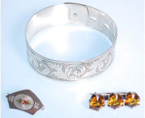 Charles Horner - A group of four silver hallmarked jewellery pieces by Charles Horner to include a bangle with engraved flora