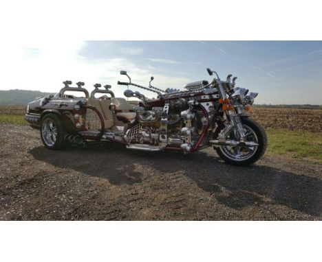 Wow! What the hell is that??? Yes ladies and gentlemen, this is exactly what it looks like… a Trike powered by a 5.3 V12 Fuel