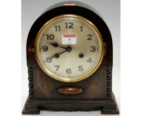A 1920s oak cased dome top mantel clock having a silvered dial with Arabic numerals and 8 day movement, striking on a gong, h
