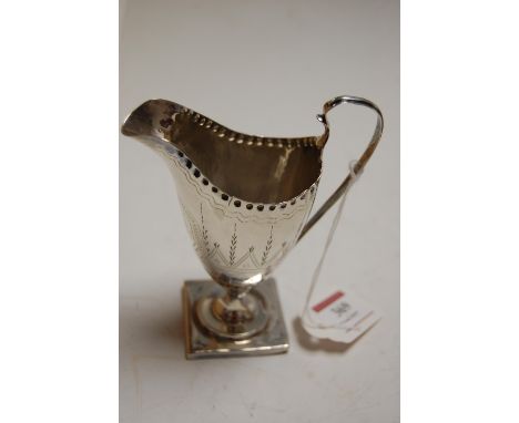 A 19th century silver helmet shaped cream jug, having bright cut decoration and initialled cartouche, 2.6oz