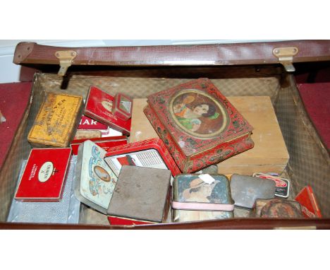 A leather suitcase containing a quantity of vintage bygone tins to include McVities