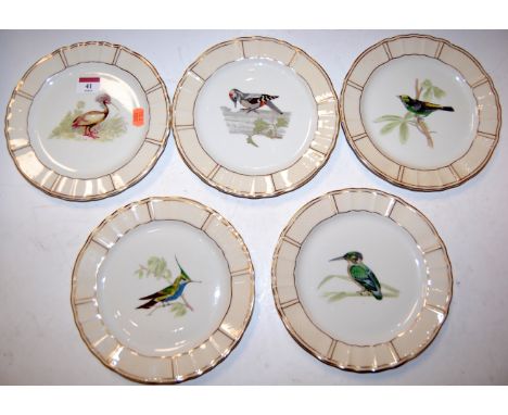 A set of eleven Limoges cabinet plates, each decorated with central bird within raised wavy border, heightened in gilt, dia. 