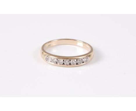 An 18ct diamond half hoop ring, the round brilliant cut diamonds, estimated approx. 0.25cts, channel set to plain band with C