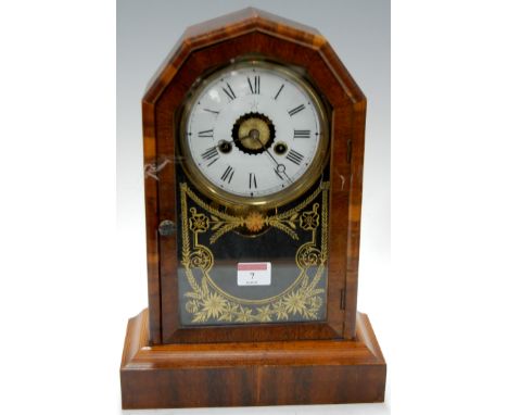 A 19th century American mahogany cased mantel clock having enamel dial with Roman numerals enclosed by glazed door, height 36