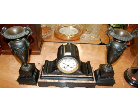A Victorian slate mantel clock having a bronze vase and slate garniture, garniture height 38cm
