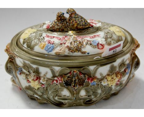 A Victorian Wedgwood majolica glazed game pie tureen and cover, the finial moulded as nesting birds, the whole moulded in rel