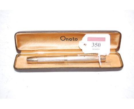 An Onoto De La Rue No.3 fountain pen, having 14ct gold nib, with unmarked engine turned yellow metal case with vacant cartouc