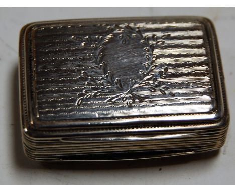A George IV silver vinaigrette, having engine turned decoration and vacant cartouche, the gilt washed interior with pierced g
