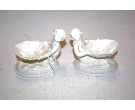 A pair of Royal Worcester blanc-de-chine figural table salts, shape No.349