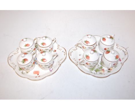 A set of four Coalport strawberry pattern cups and covers on stand, together with one other matching set