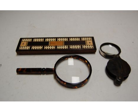 A Victorian rosewood cribbage scorer; together with a faux tortoiseshell magnifying glass; and a horn pocket magnifying glass