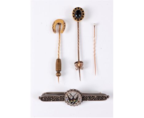 A 15ct horseshoe stick pin, a banded agate and black enamel stick pin, a cultured pearl stick pin and a white metal and micro