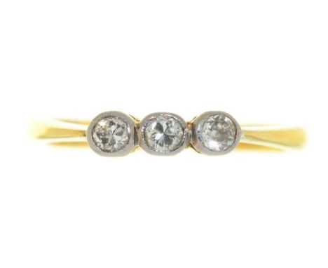 A THREE STONE DIAMOND RING, RUBOVER SET IN GOLD MARKED 18CT, SIZE O, 2.5G++LIGHT WEAR CONSISTENT WITH AGE 