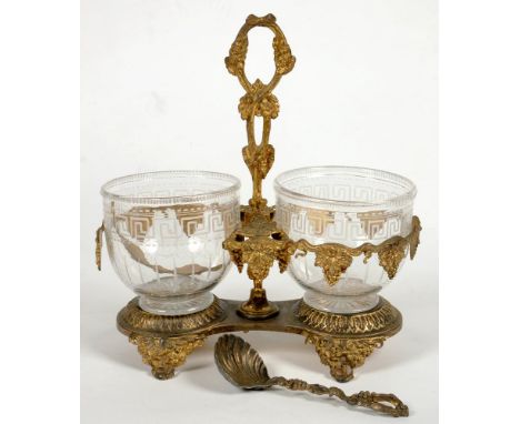 A VICTORIAN ELECTRO-GILT CREAM AND SUGAR STAND AND CREAM LADLE, THE OPENWORK HANDLE CAST WITH GRAPE VINES RETAINING THE PAIR 