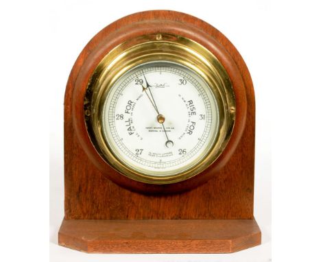 A SESTREL BRASS ANEROID BAROMETER, INSCRIBED HENRY BROWNE &amp; SON LIMITED BARKING LONDON, MOUNTED ON AN OAK STAND, 26CM H